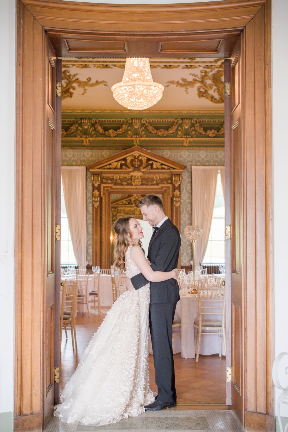Bride & Groom embracing and smiling at one another in doorway at Hawkstone Hall & Gardens